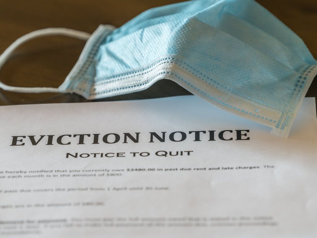 eviction notice with a medical mask sitting on top